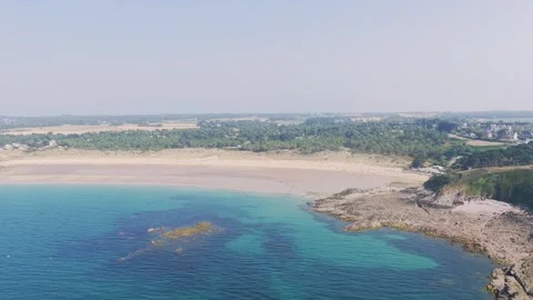Aerial view of the expansive sandy beach and rugged rocky coastline of Anse du Stock Footage 346666515