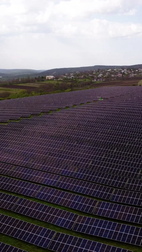Aerial view of expansive solar panel field showcasing rows of photovoltaic cells Stock Footage 325201620
