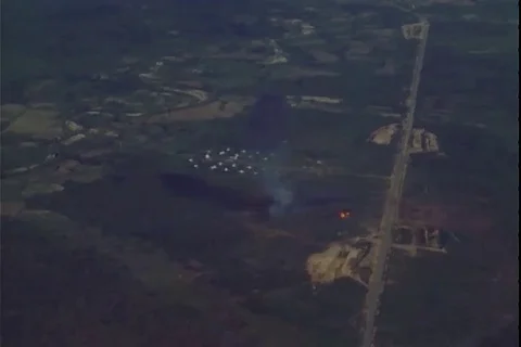 Aerial view of explosions in enemy positions and gunner fires at ground - 1972 Stock Footage 106060692