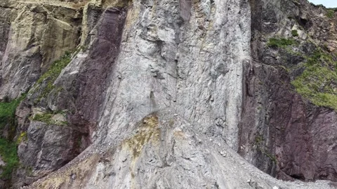 Aerial View of Exposed Rock Face on Steep Cliff Formation Stock Footage 337398048