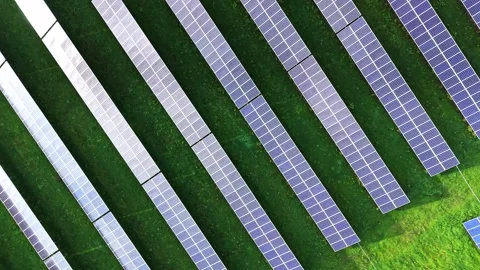 Aerial view of extensive solar panel field in a green landscape Stock Footage 325087605