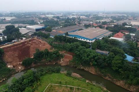 An aerial view of factory complex next to a river Stock Photos
