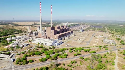 Aerial view of a factory with a large red and white pipe at a production area. Stock Footage 163336097