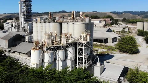 Aerial View of Factory Surrounded By Trees Stock Footage 142304609