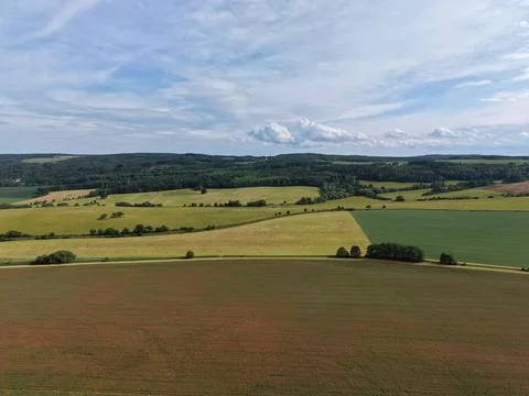 An aerial view of farm fields and forest under a wide blue sky, Czech Republic Stock Photos