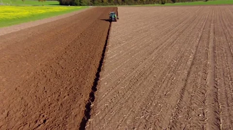 Aerial view of a farmer plowing a huge field with his tractor. Stock Footage 43065952