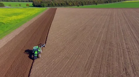 Aerial view of a farmer plowing a huge field with his tractor. Stock Footage 43066587