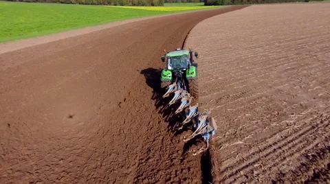 Aerial view of a farmer plowing a large field with his tracor. Stock Footage 43065518