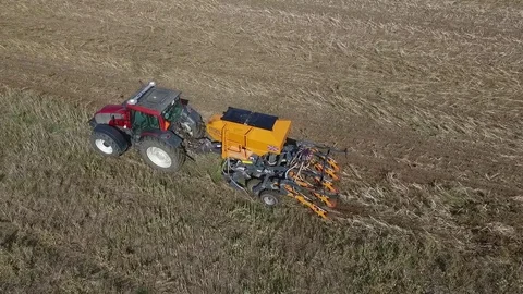 Aerial View Of A Farmer is Sowing Corn On A Huge Field Stock Footage 85290322