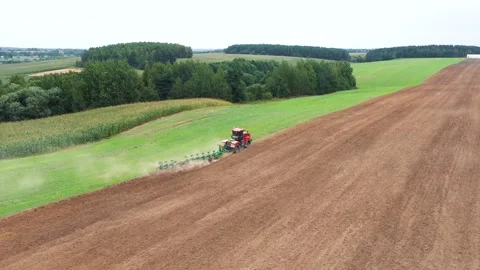 Aerial View Farmer On Tractor Plows Fertile Agricultural Hilly Land With Plow Stock Footage 220291176