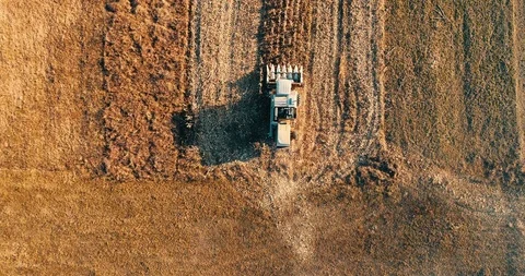 Aerial view of farmer using combine harvester Stock Footage 100971255