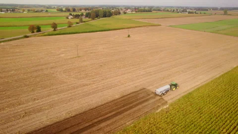 Aerial view of a farmer using a tractor to plough a field Stockbeeldmateriaal 348458243