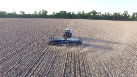Aerial View Farming Planting Corn with a Blue Tractor, Follow Along Perspective Stock Footage
