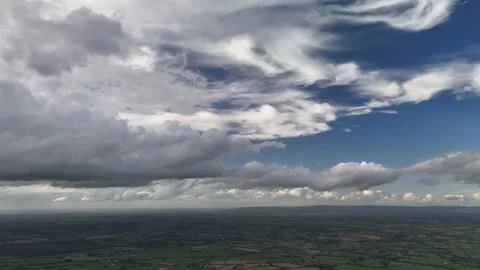 Aerial View of Farmland Beneath Dramatic Cloudy Sky Stock Footage 337851969