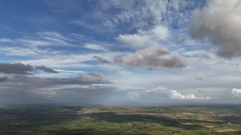 Aerial View of Farmland Beneath Dramatic Cloudy Sky 库存影片 337852323