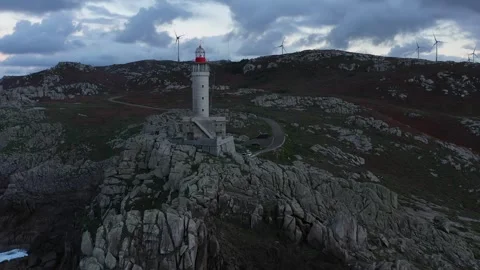 Aerial view of Faro de Punta Nariga on rocky cliffs, Spain. Stock Footage 336108253