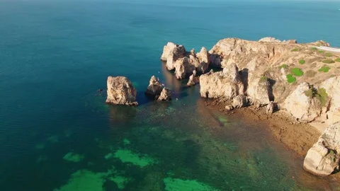 Aerial view of Farol da Ponta da Piedade Lighthouse by the rocky cliffs of Lagos Stock Footage 163339522