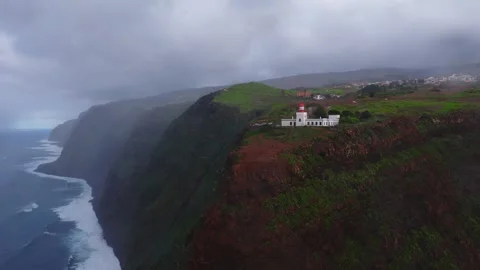 Aerial view of Farol da Ponta do Pargo on Madeira's rugged coast 스톡 동영상 323444621