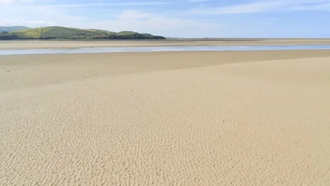 Aerial view, fast forward move. Drone panorama over low tide sea and pristine Stock Footage 94245794