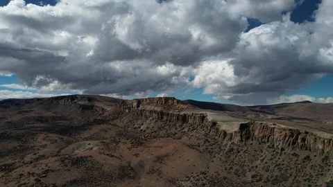 Aerial View Of Fast Moving Clouds Over Rugged Cliff Landscape Patagonia Stock Footage 332599703