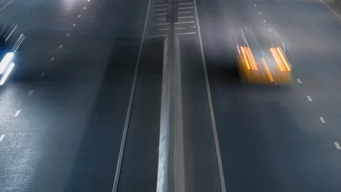 Aerial view of fast moving freeway traffic. Fast moving cars leave light streaks Stock-Footage 121100119