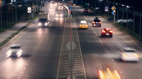 Aerial view of fast moving freeway traffic. Night. Road goes beyond the horizon Stock Footage 121100188