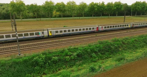 Aerial view of fast passenger train driving on railroad. High angle view of Stock Footage 219568560