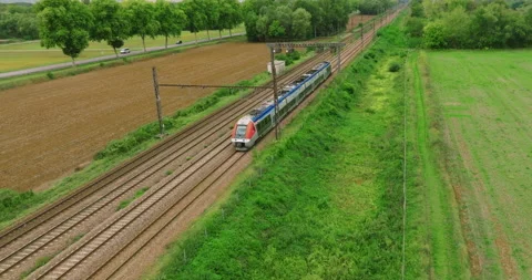 Aerial view of fast passenger train driving on railroad. High angle view of 스톡 동영상 220503316