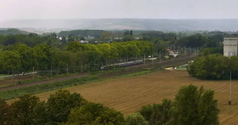 Aerial view of fast passenger train driving on railroad. High angle view of Stock Footage 226139412