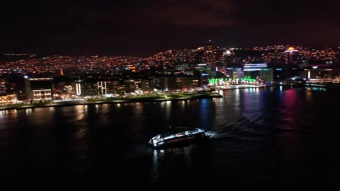 Aerial view of the ferry advancing on the Aegean Sea with a night view of the 스톡 동영상 236814758