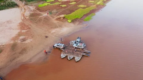Aerial view of a ferry transporting four by four cars across a river in 스톡 동영상 308404823