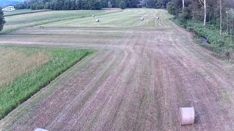 An aerial view of a field that has been plowed and filled with hay bales 3 Stock Footage 250356976