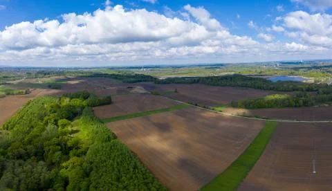 Aerial view of fields and forests in spring with beautiful clouds Stock Photos