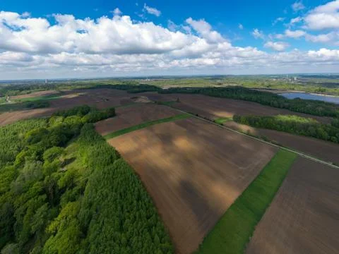 Aerial view of fields and forests in spring with beautiful clouds Stock Photos