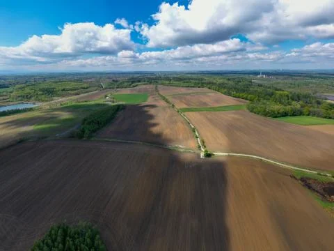 Aerial view of fields and forests in spring with beautiful clouds Stock Photos