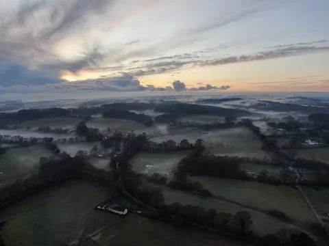 An aerial view of fields and the hedges on a misty evening Stock Photos
