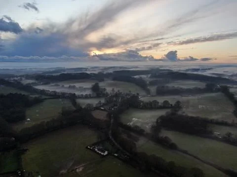 An aerial view of fields and the hedges on a misty evening Stock Photos
