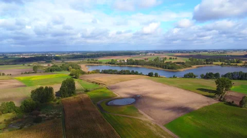 Aerial view of fields and lake Stock Footage 221625156