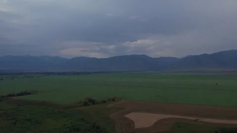 Aerial view of fields and mountain range near Zamulta village, Altai region Stock Footage 336296554