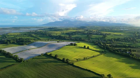Aerial view of fields and rolling hills with Mourne Mountains during sunset.. Stock Footage 337322838