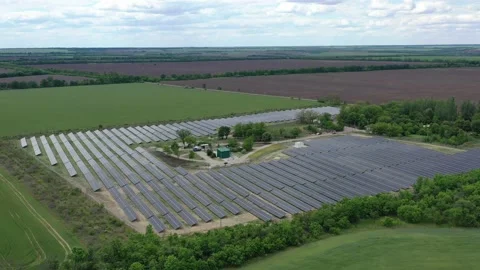 Aerial view on the fields with a big solar power station on them, 4k Stock Footage 134003687