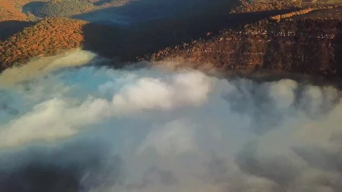 Aerial view of fields on a hill above the clouds Stock Footage 105963213