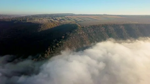Aerial view of fields on a hill above the clouds Vidéo 119659974