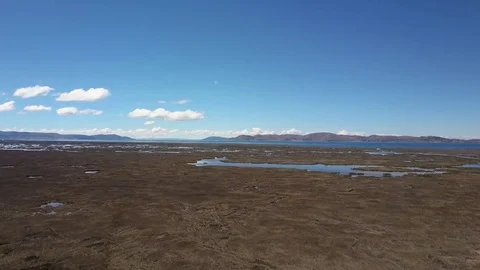 Aerial view of fields, mountains, swamps, and lake Titicaca. Stock Footage 76640906