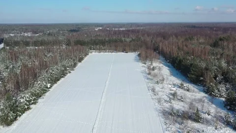 Aerial view of fields in the winter with car passing by Stock Footage 247454266