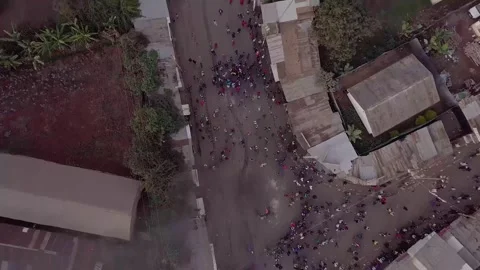 Aerial view of a fiery protest with burning tires blocking road, demonstrat.. Stock Footage 337763947