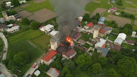Aerial view of fire brigade, fire truck extinguishing blaze in Svan tower in Stock Footage 281245337