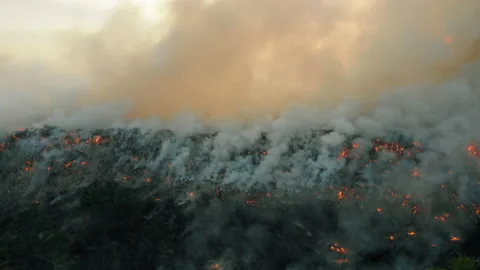Aerial view at fire at garbage dump, burning pollutes the environment Video stock 139793833