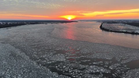 Aerial View of a Fire Sky Sunset over Frozen Delaware River Stock Footage 304565886