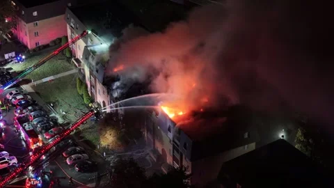 Aerial View of Firefighters Fighting a Multi-Alarm Fire at an Apartment Complex Stock Footage 320988209